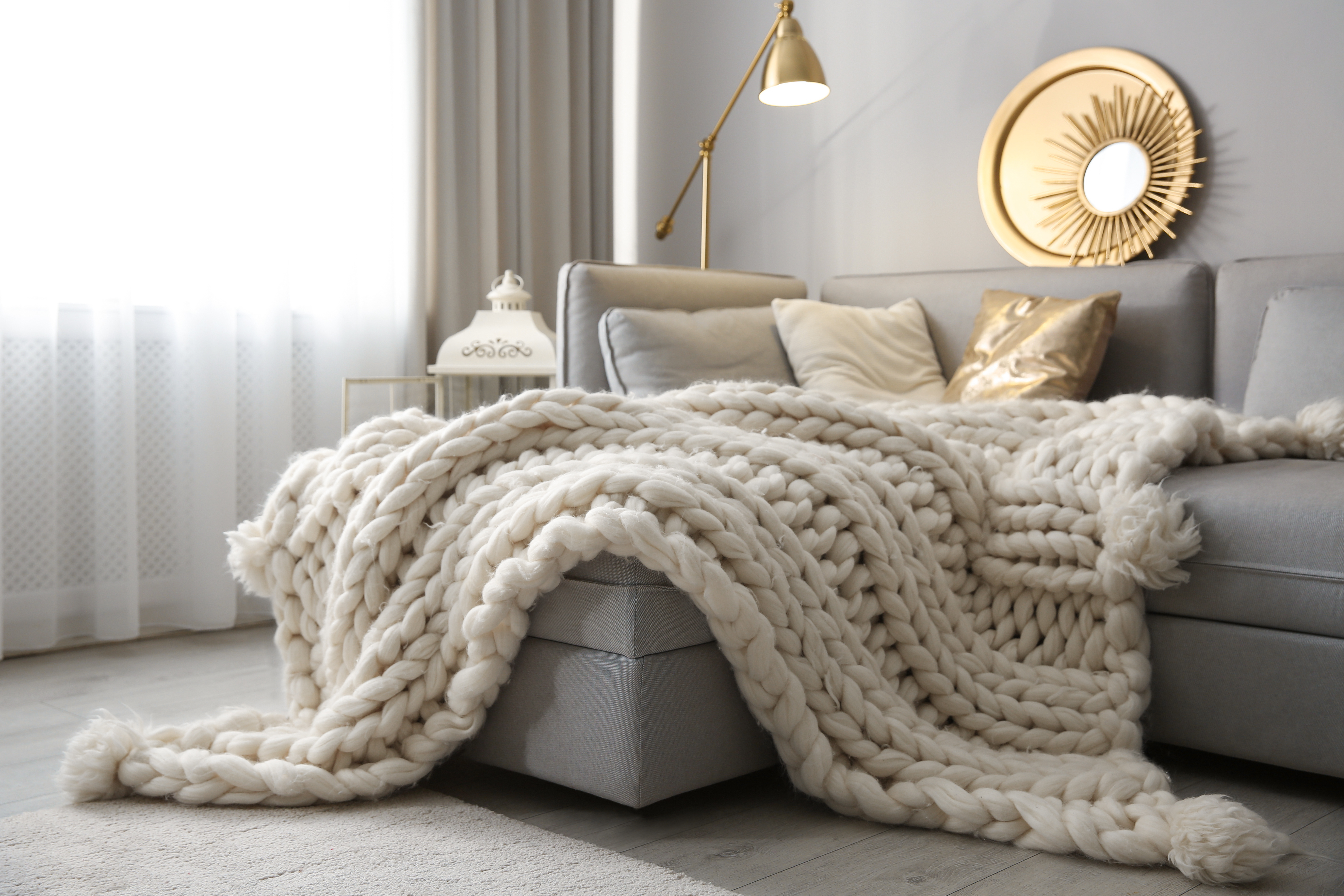 Cozy living room interior with knitted blanket on comfortable so Hyggelig im Sauerland